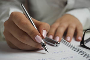 An image for Winterslow Parish Council website showing someone writing 